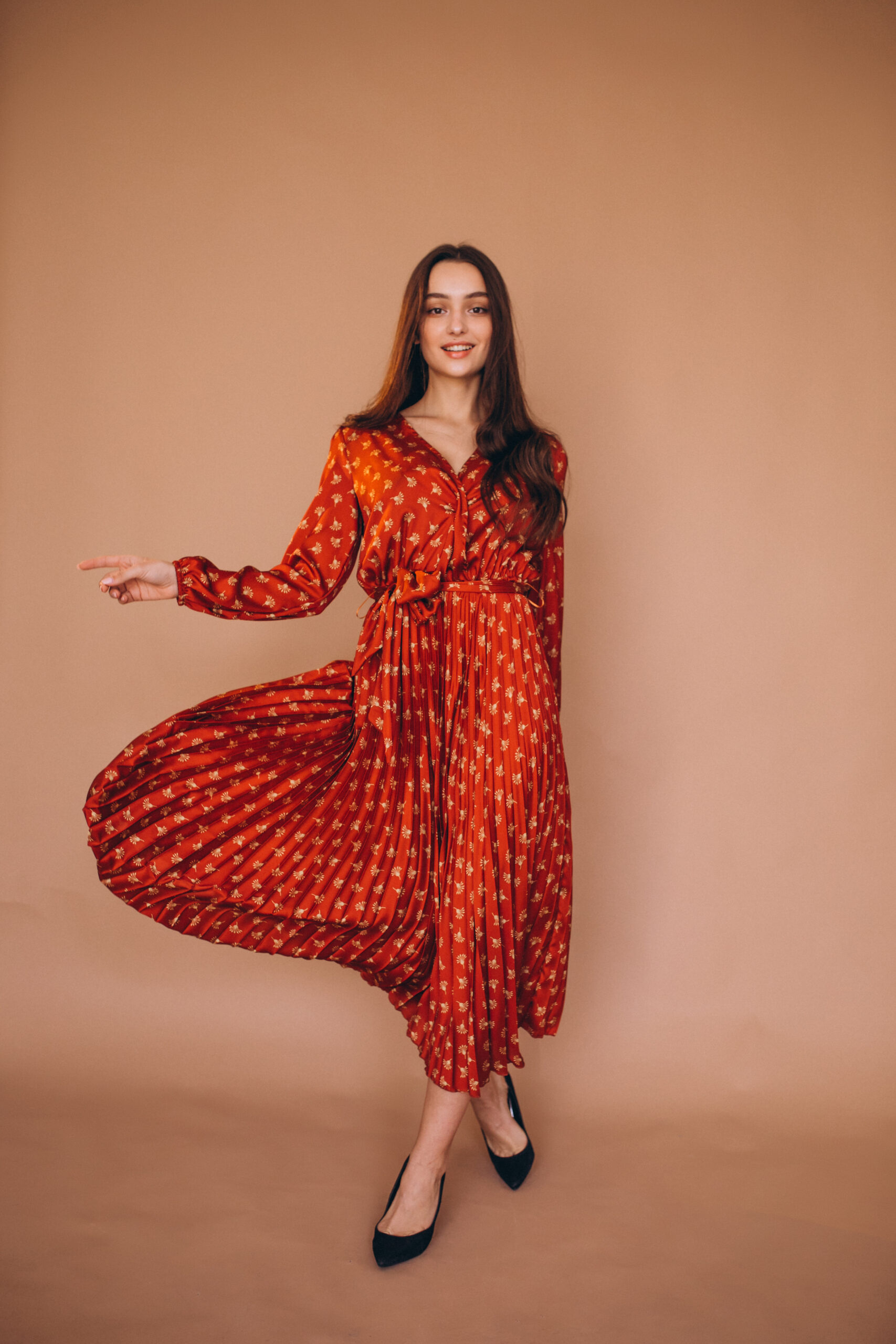 Young woman in a beautiful red dress in studio